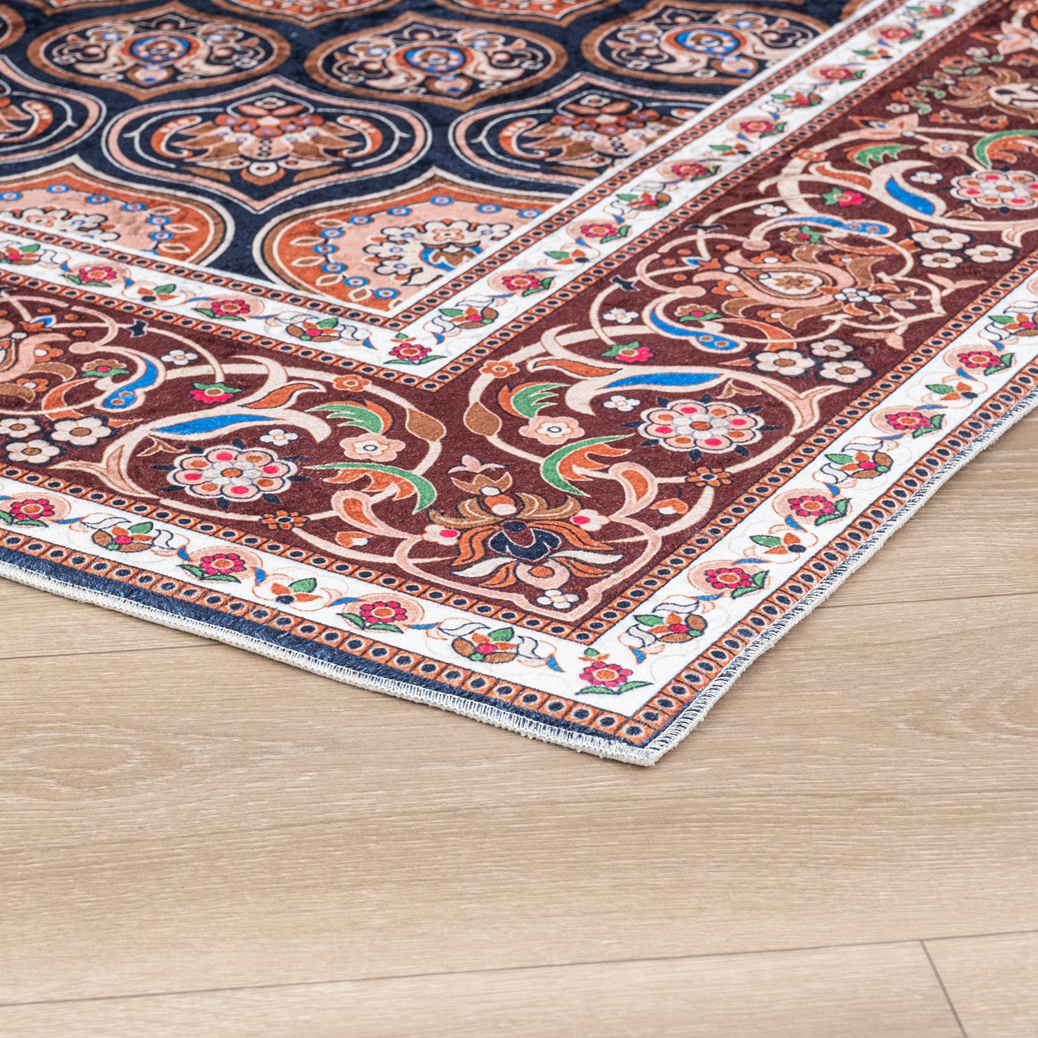 Red / Navy Bursa machine washable area rug 2' x 3' - corner detail on hardwood floor