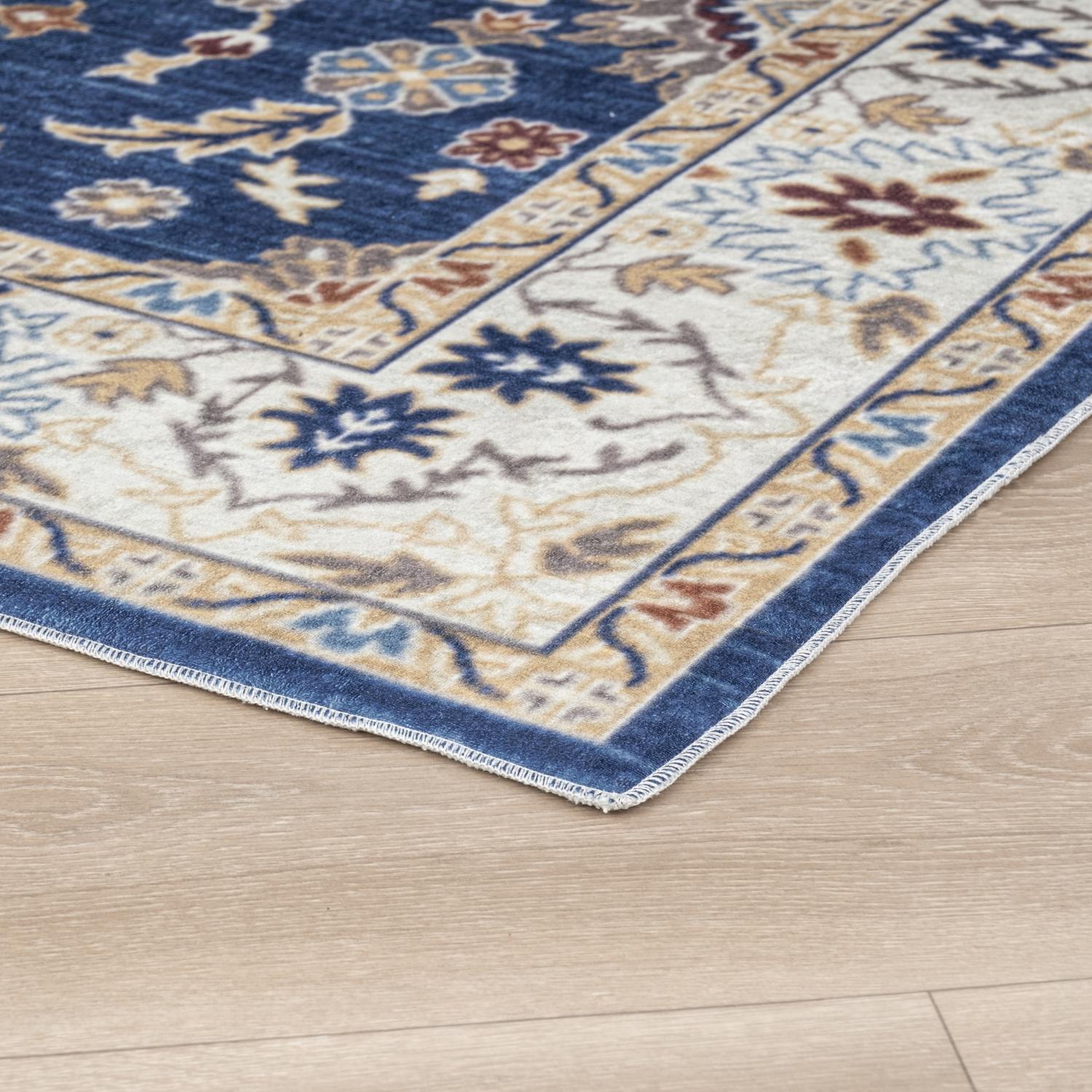 Navy Bursa machine washable area rug 3' x 5' - corner detail on hardwood floor