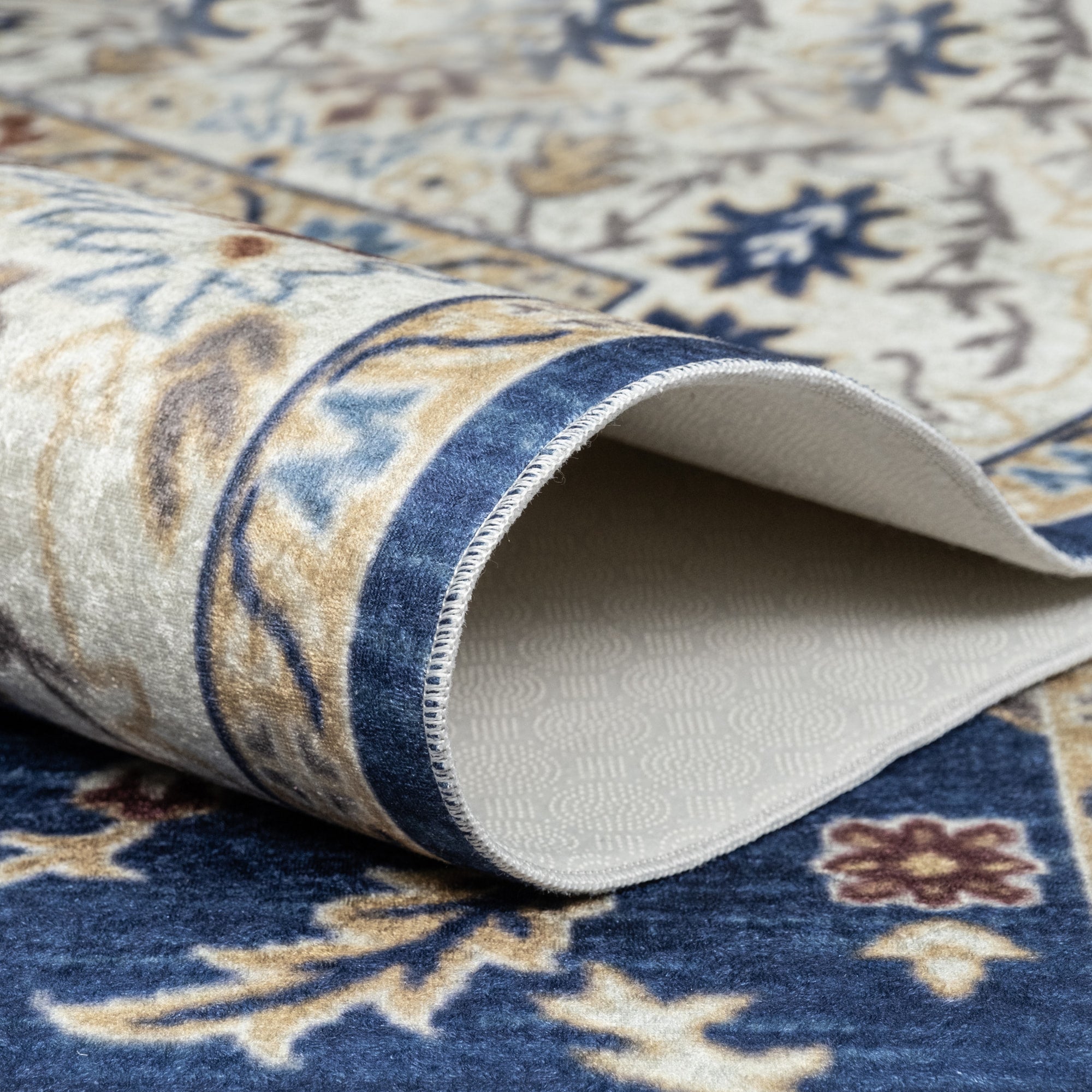 Navy Bursa machine washable area rug 4' x 6' - folded to show the non-slip backing