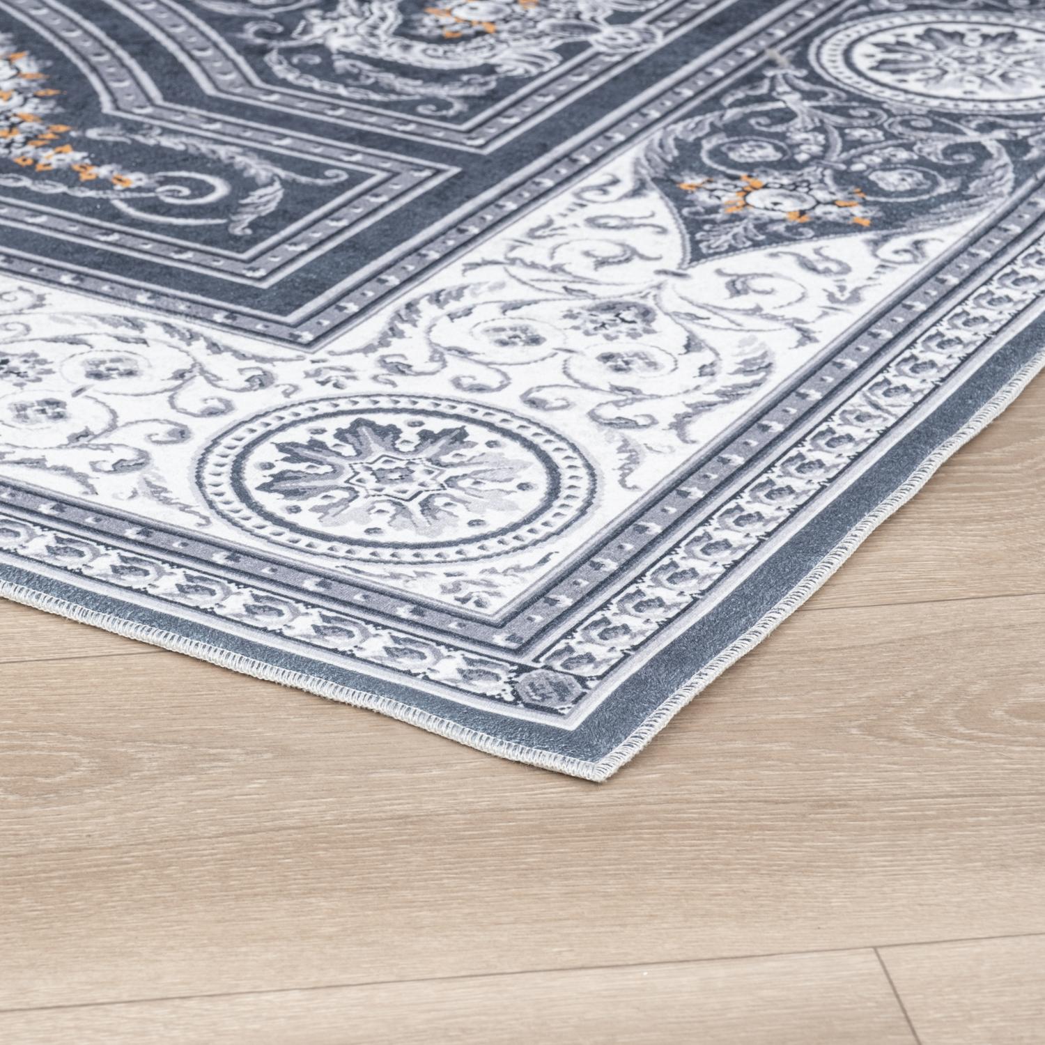 Gray Bursa machine washable area rug 2' x 3' - corner detail on hardwood floor