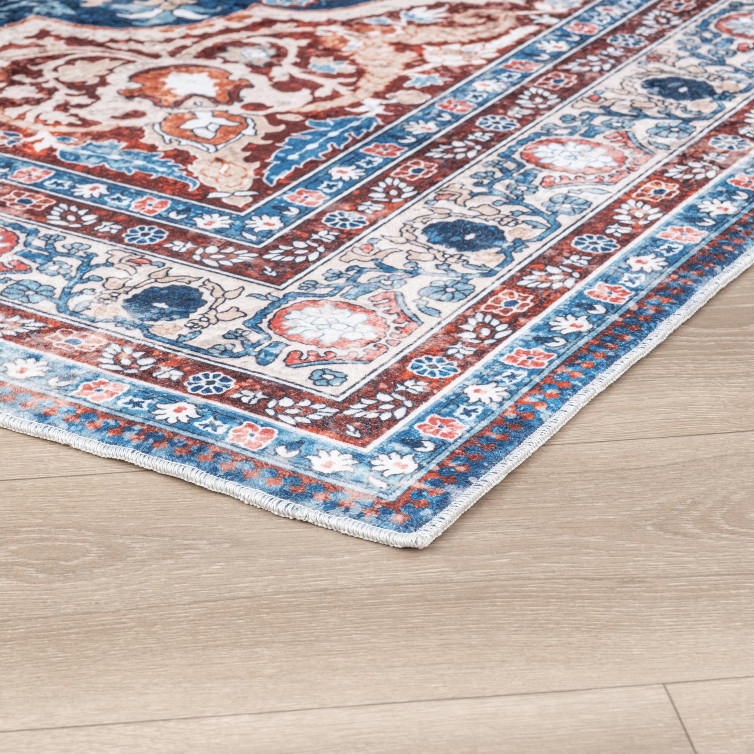 Peach Bursa machine washable area rug 4' x 6' - corner detail on hardwood floor