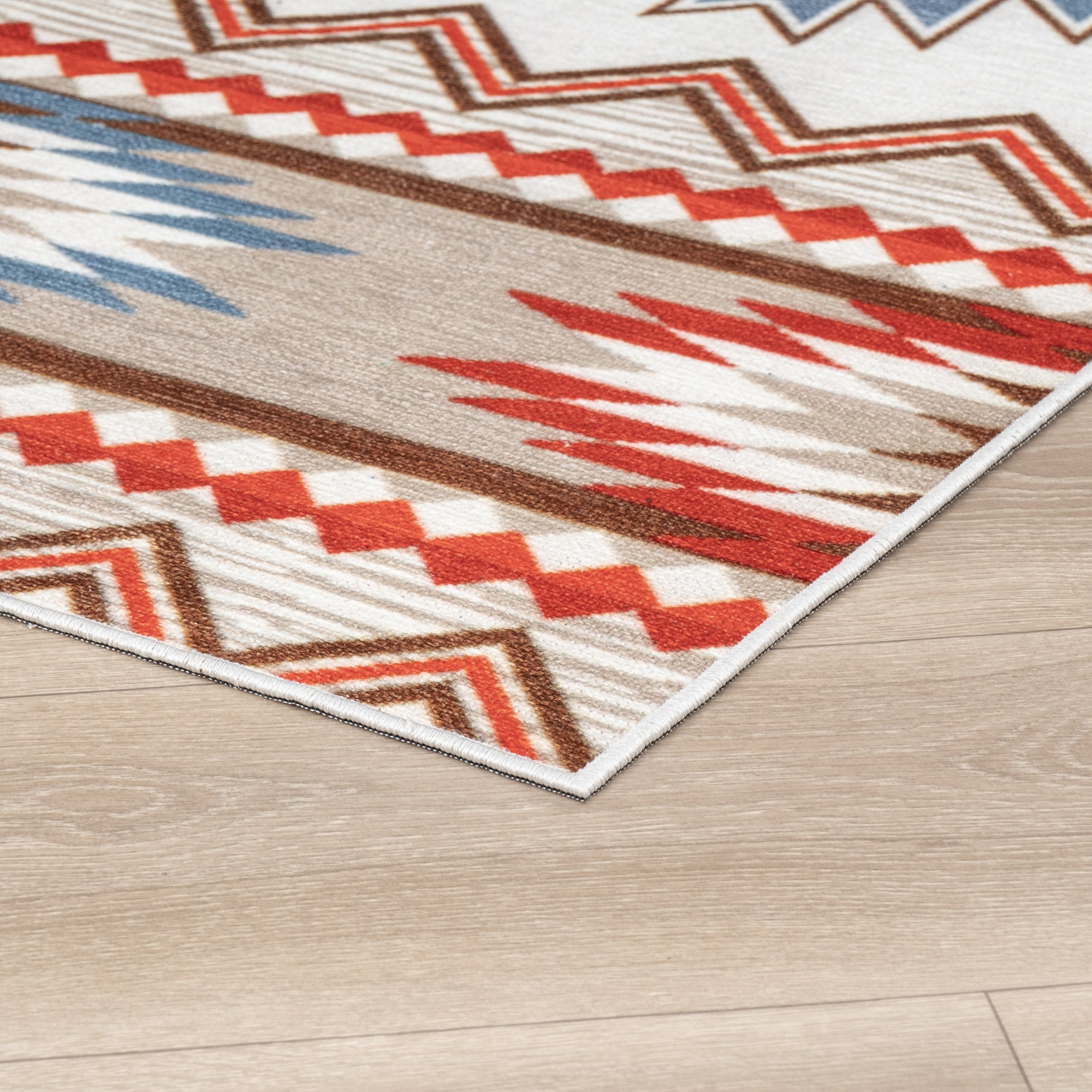 Ivory Konya machine washable area rug 4' x 6' - corner detail on hardwood floor