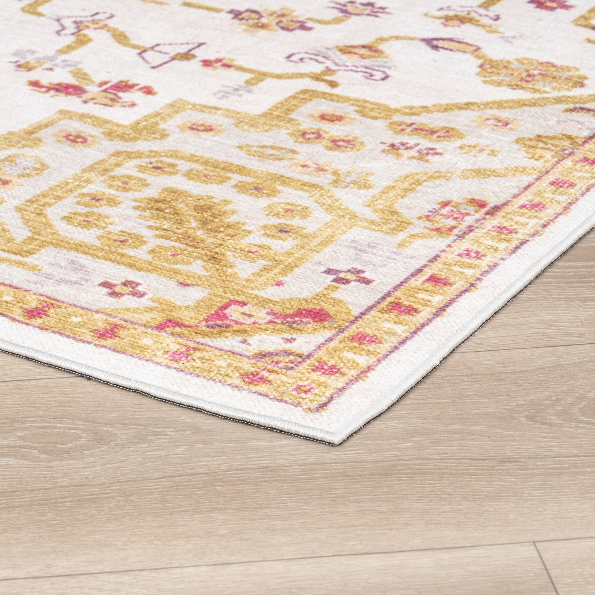 Ivory Konya machine washable area rug 4' x 6' - corner detail on hardwood floor
