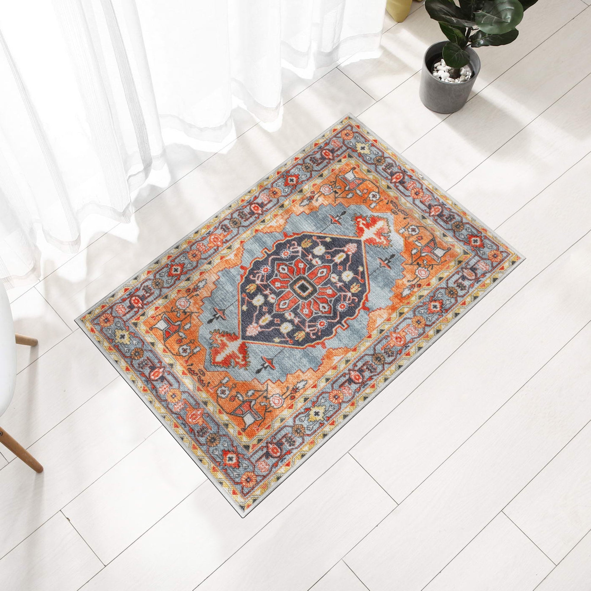 Orange Konya machine washable area rug 2' x 3' - styled in a room