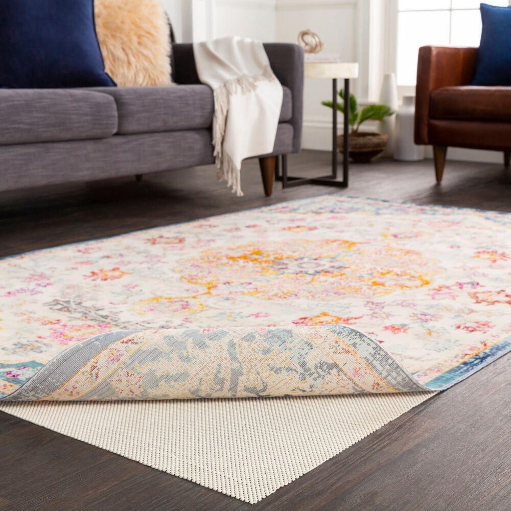 Support Grip rug pad under an area rug in a living room